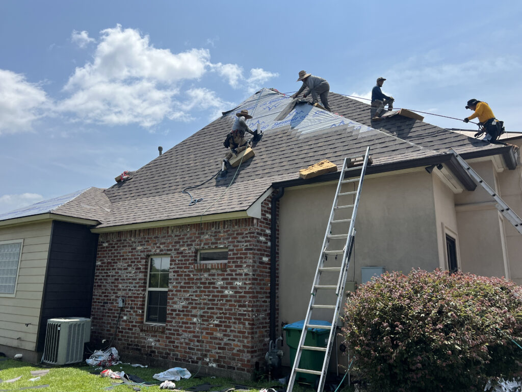 Roofing crew installing shingles