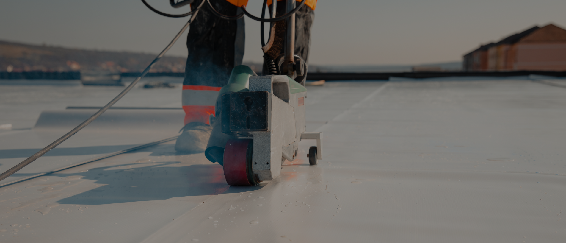 Roofing equipment installing commercial roof material