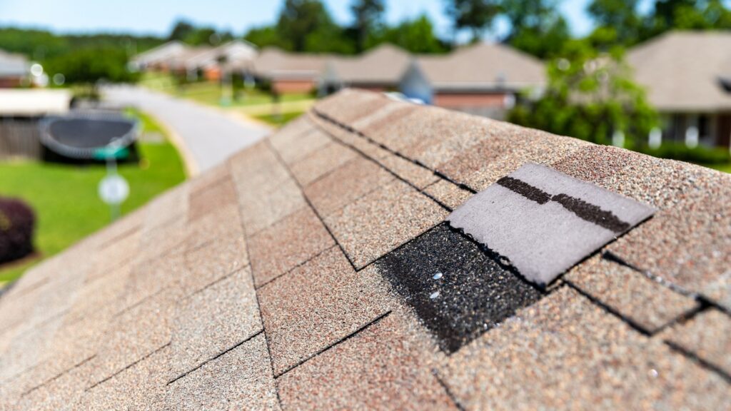 Patched shingle roof repair close-up